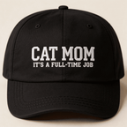 Front view of a black embroidered baseball cap with white text that says "CAT MOM IT'S A FULL-TIME JOB"