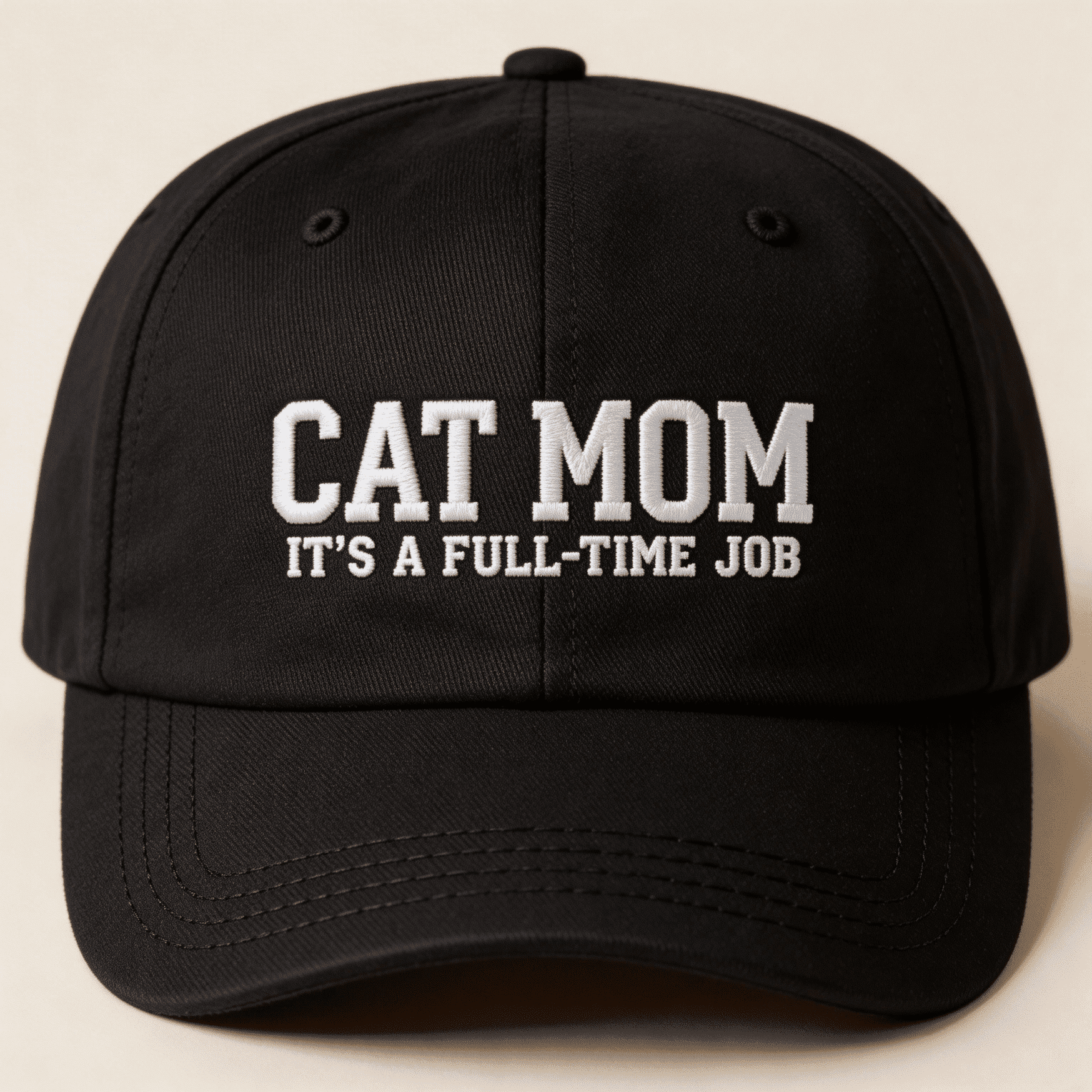 Front view of a black embroidered baseball cap with white text that says "CAT MOM IT'S A FULL-TIME JOB"