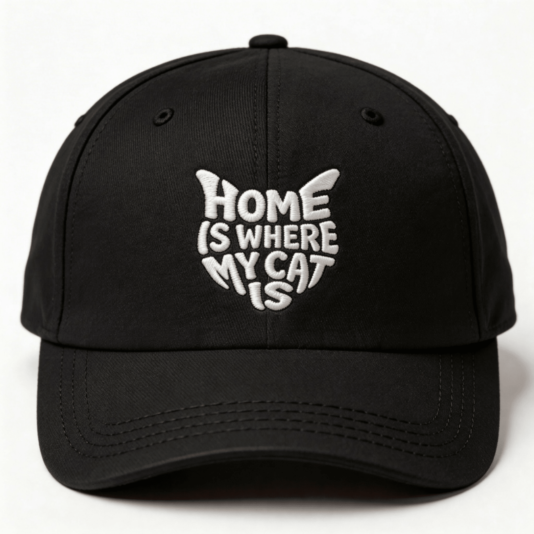Black embroidered cap with white text that says “Home Is Where My Cat Is” shown from the front