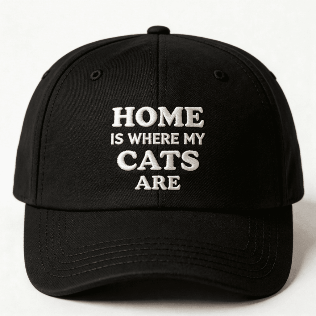 Black cap with white text that says “Home Is Where My Cats Are” shown from the front