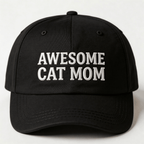 Black embroidered cap with white text that says “Awesome Cat Mom” shown from the front