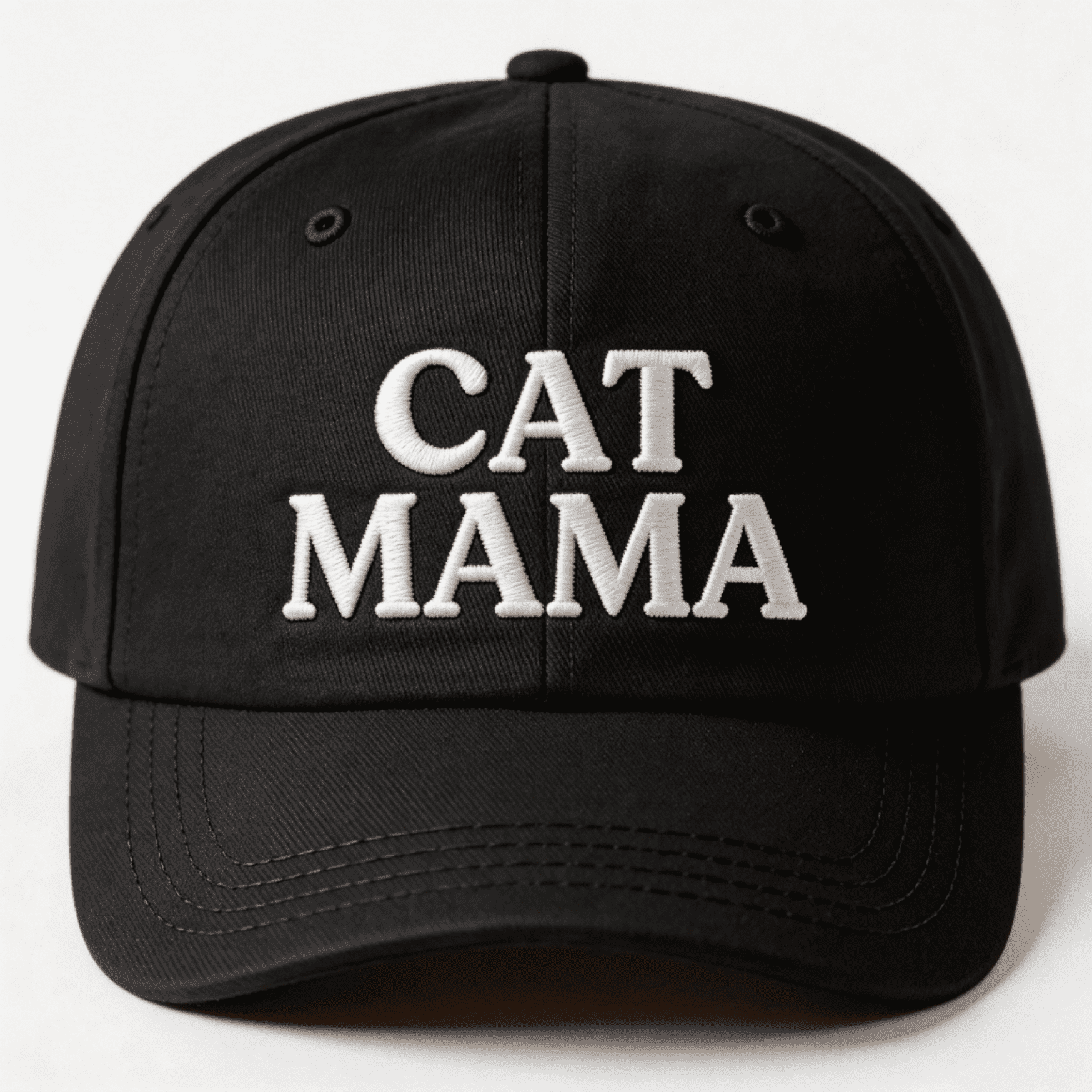 Black embroidered cap with white text that says “Cat Mama” shown from the front