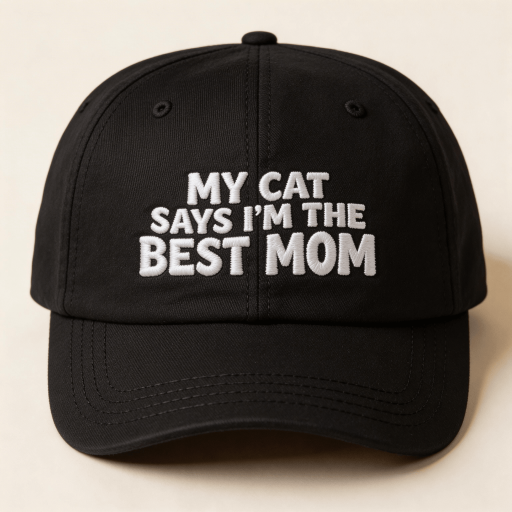 Black embroidered cap with white text that says “My Cat Says I’m The Best Mom” shown from the front