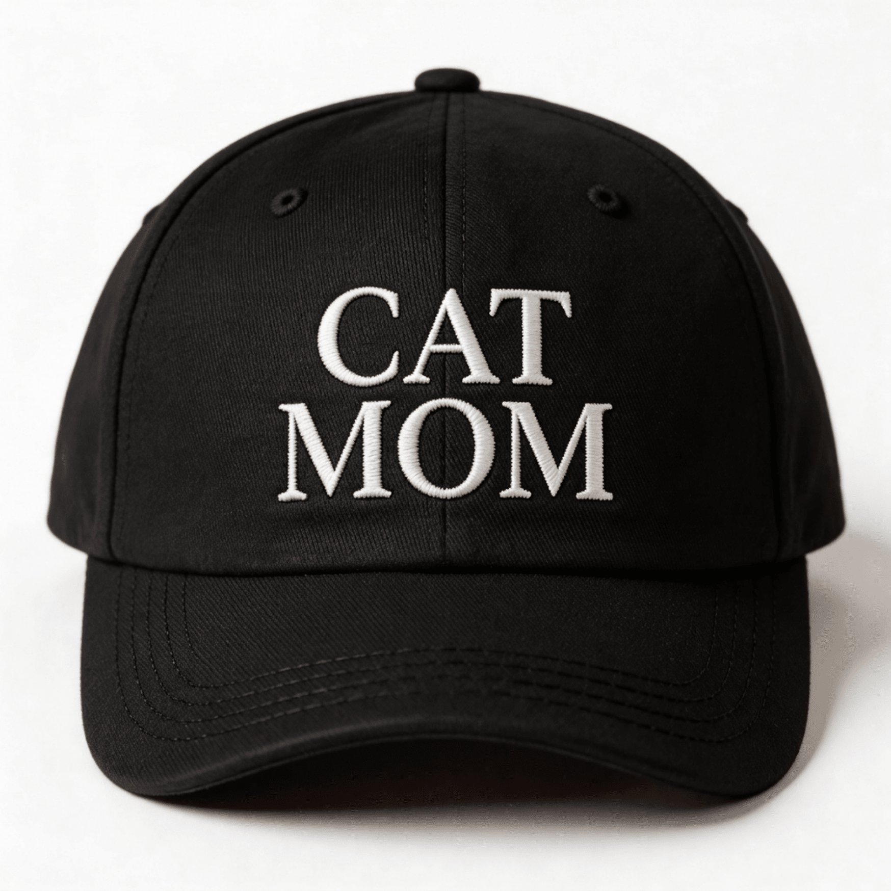 Black embroidered cap with white text that says “Cat Mom” shown from the front