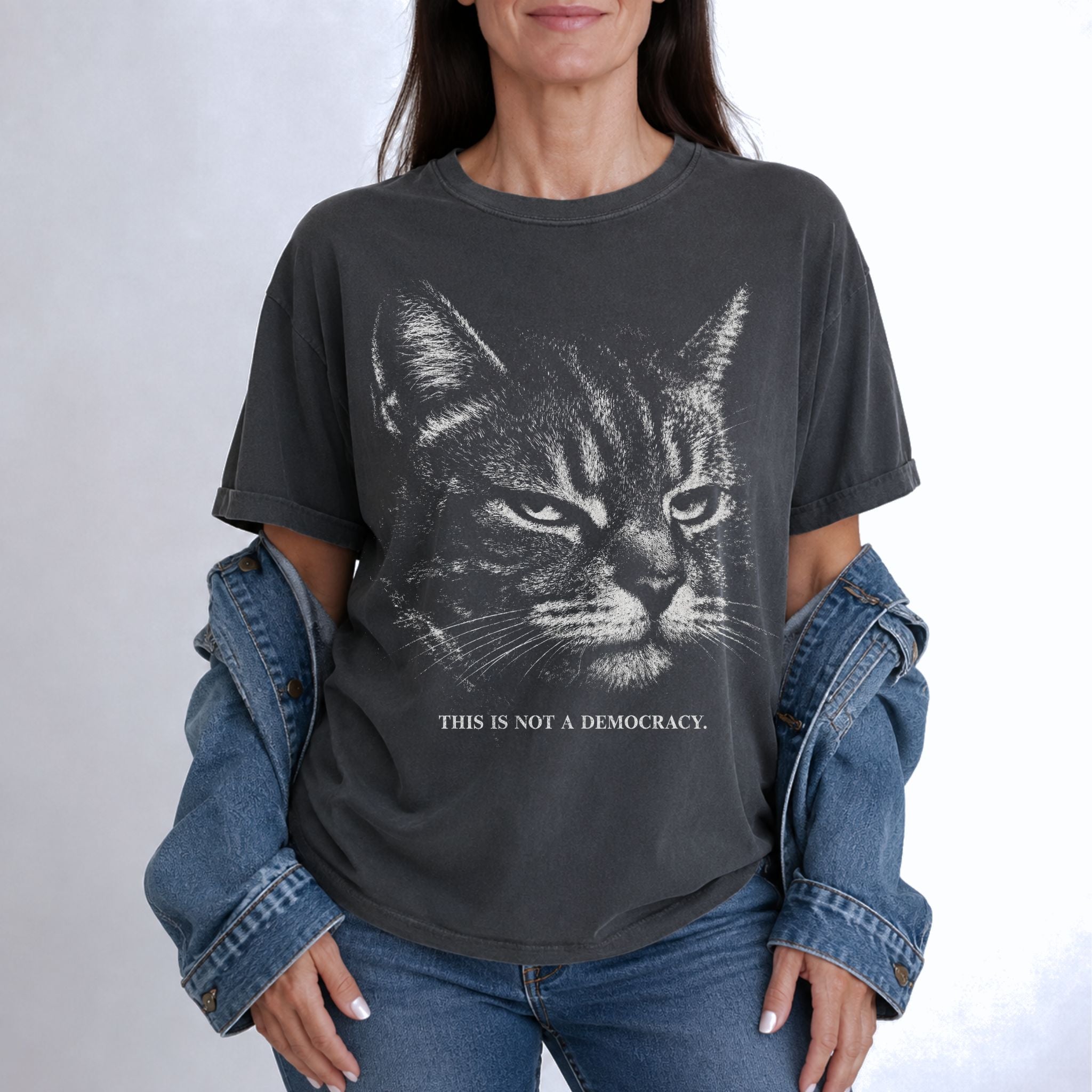 Woman wearing a Pepper cat t-shirt with stern tabby cat and This Is Not A Democracy text