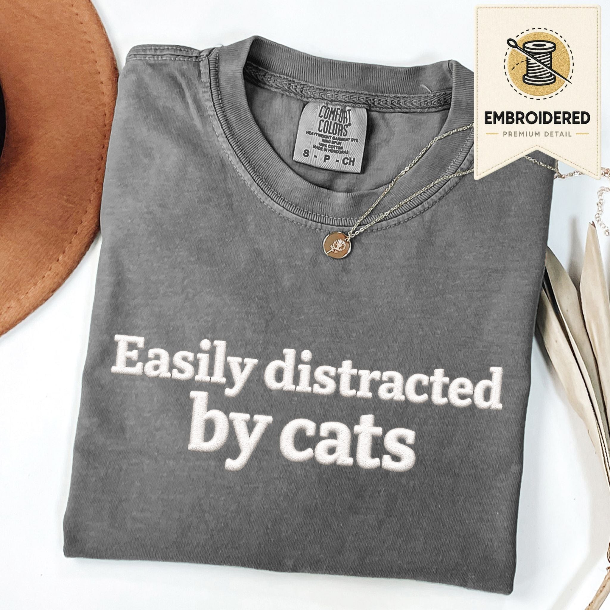 Pepper embroidered cat t-shirt with 'Easily Distracted' chest design, shown flat